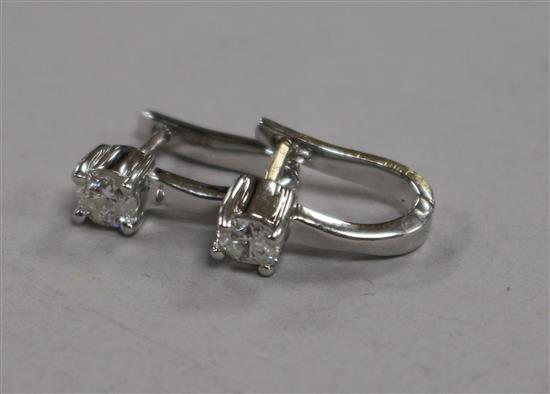 A pair of 18ct white gold and solitaire diamond ear studs.